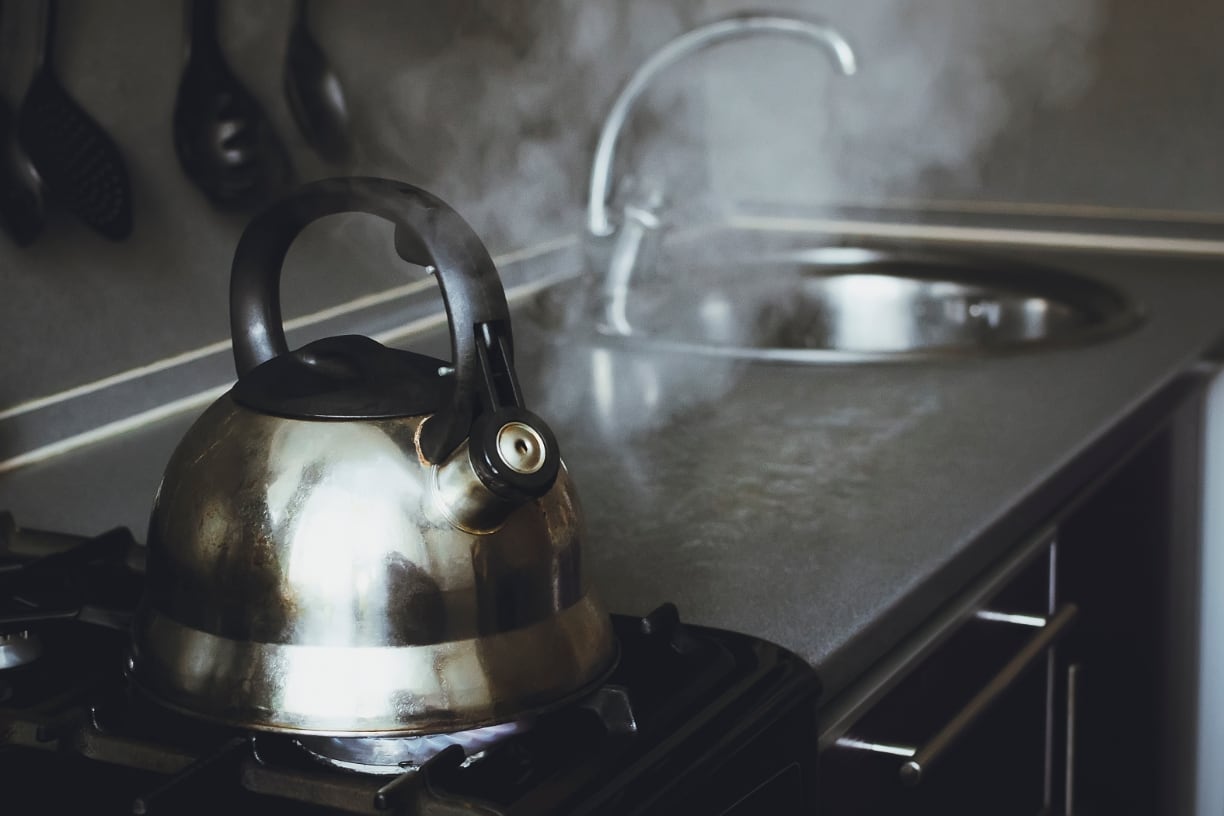 Tea kettle on stove boiling